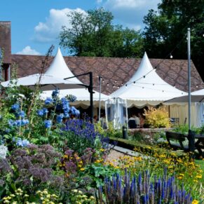 The Five Arrows Hotel wedding marquee and former stables captured under near perfect blue skies