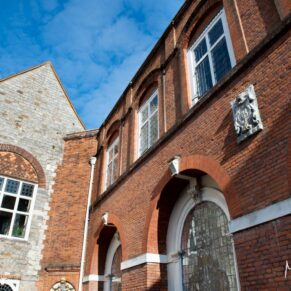 Photography of the exterior of Farnham Castle from the courtyard on a spring wedding day