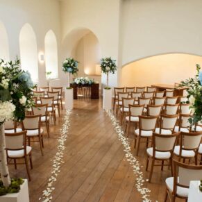 Wide angle photography of the grand interior setup for the civil wedding ceremony at Farnham Castle
