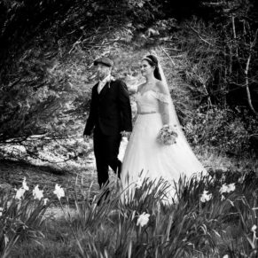 The newlyweds stroll through the trees and towards the summerhouse on this stunning spring day
