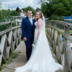 Swan at Streatley wedding - newlyweds captured on the bridge after the ceremony