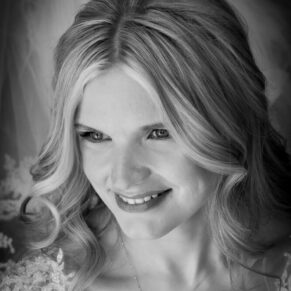 Swan at Streatley wedding - dramatic window-lit pose of the smiling bride on her special day