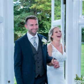 The Olde Bell Hurley Wedding Photography - the newlyweds are cheered into the room