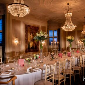 Atmospheric lighting fills the wow interior room setup and banqueting table for this wonderful winter wedding breakfast at Danesfield House Hotel