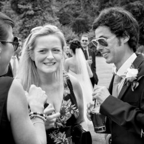 Reportage capture of some lively guests during the wedding drinks reception at Danesfield House Hotel