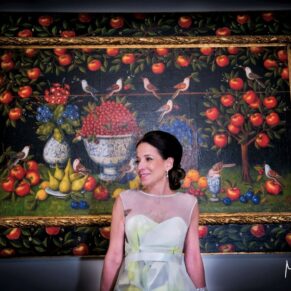 The bride captured beside one of the many huge wow paintings kept at her wedding venue - Danesfield House