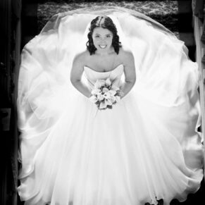 Full length bridal portrait on Hartwell House's Jacobean staircase captured from high above to showcase the detailed gown to perfection