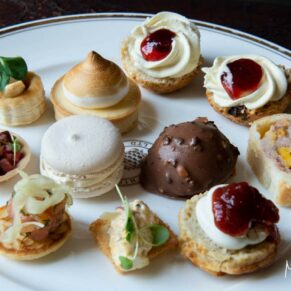 Divine afternoon tea style canapes placed on a porcelain platter for the guests at Hartwell House Hotel