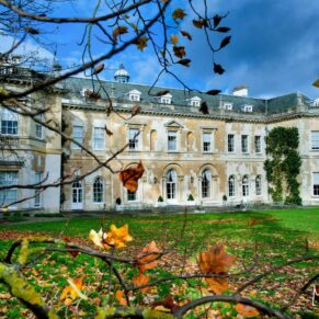The rear of Hartwell House on an autumnal day under near perfect blue skies