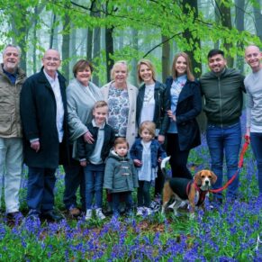 This larger group pose was captured in a colourful bluebell woods in the Buckinghamshire countryside during a rain soaked family photography portraits session