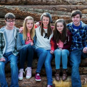 This rustic natural pose of five teenagers was captured in a Chilterns woodland setting