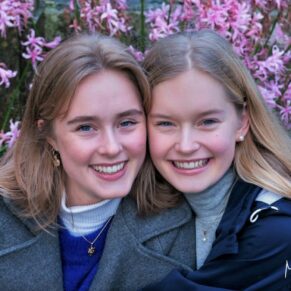 This pose of two young sisters sat amongst the pink flowers was captured in the colourful gardens at Cliveden House in Buckinghamshire