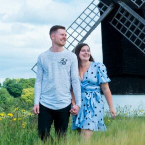Couple portraits taken at a Buckinghamshire windmill location - this natural walking shot really captured their lovely smiles during the photography session