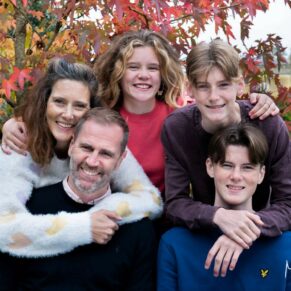 Relaxed family portrait of five captured in a Chilterns woodland setting for their Buckinghamshire photo session