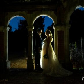 The bride and groom captured inside the old folly within the venue's grounds at dusk