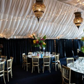 The Dining Room at The Crazy Bear Hotel in Stadhampton all setup for the wedding breakfast with an exotic tropical themed colour scheme