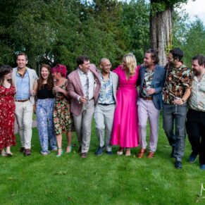 The wedding guests take a relaxed stroll through the gardens at The Crazy Bear Hotel in Stadhampton