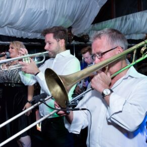 The live wedding band performing the night away inside the marquee at The Crazy Bear Hotel in Stadhampton