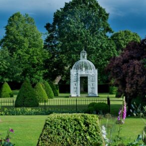 The view across the gardens towards the rose arbour on a fabulous summer's day at Chenies Manor House