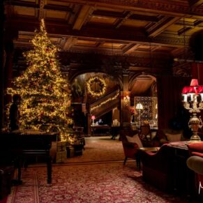 Dramatic interior of the Great Hall captured at this Christmas wedding with all the festive decorations of Cliveden House