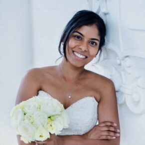 Buckinghamshire Asian Wedding Photography bridal portrait captured at Danesfield House with her leaning close to the stone coat of arms