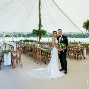 The newlyweds pose for the camera inside the fabulous marquee before all the guests enter
