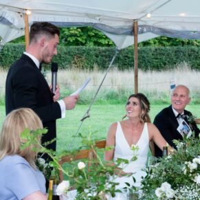 The groom's fabulous speech in progress in the marquee with distant views of the surrounding gardens