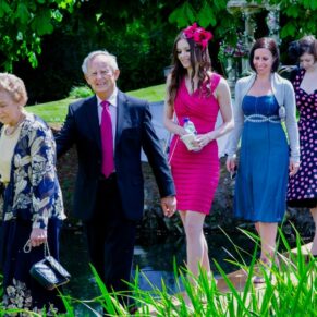 Guests crossing the narrow wooden bridge to reach the outdoor civil wedding ceremony area on the island
