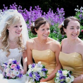 The bride and her two bridesmaids in a close-up pose looking away from the camera at this historic Oxfordshire venue