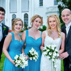 The bridal party pose for the camera in front of the White House at this informal Beaumont Estate summer wedding