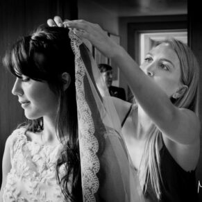 Buckinghamshire Black and White Wedding Photography - the bride has some final veil adjustments mage just prior to her civil ceremony