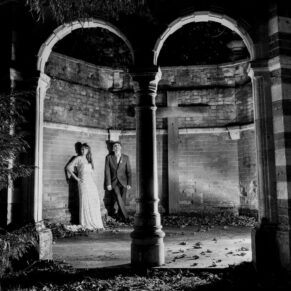 Buckinghamshire Black and White Wedding Photography - night-time photo of the newlyweds captured in the woodland folly at the Tudor Barn in Burnham
