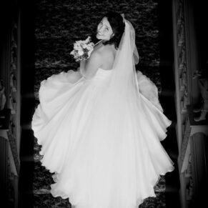 Buckinghamshire Black and White Wedding Photography - dramatic shot of the bride captured from above on the grand staircase at Hartwell House