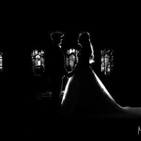Buckinghamshire black and white wedding Photography of dusk silhouette pose of the newlyweds at Missenden Abbey