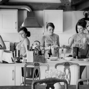 Buckinghamshire Black and White Wedding Photography - a relaxing morning at the bride's home with this natural pose of the bridesmaids captured in the kitchen
