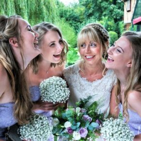 Candid and reportage Buckinghamshire wedding photographer - the bride sings a favourite musical song with her bridesmaids