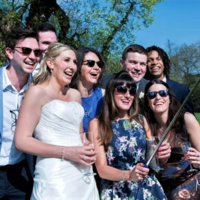 Candid and reportage Buckinghamshire wedding photographer - selfie time for this group of friends posing with the bride