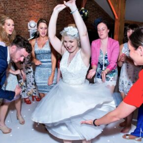 Candid and reportage Buckinghamshire wedding photographer - the bride spinning around on the dancefloor