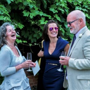 Candid and reportage Buckinghamshire wedding photographer - lots of laughter shared between these three guests during the drinks reception