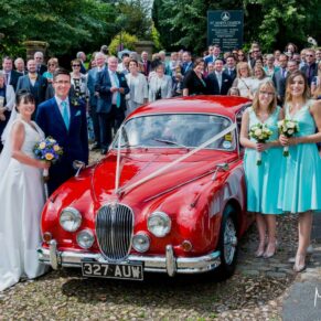 Buckinghamshire Church Wedding Photography - all the guests gather around the shiny red car