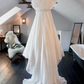 The bride's gown hanging up prior to her ceremony at the Kings Chapel in Old Amersham