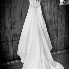 The bride's gown hanging up before her civil ceremony at her Kings Chapel wedding in Old Amersham