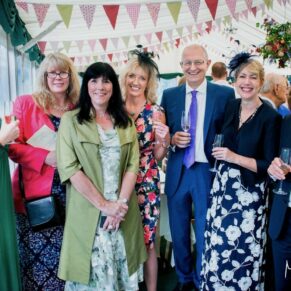Buckinghamshire Marquee Wedding Photography - group of friends pose for the camera in this colourful interior