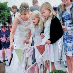 Buckinghamshire Marquee Wedding Photography - the bride shows these young ladies her fish pond