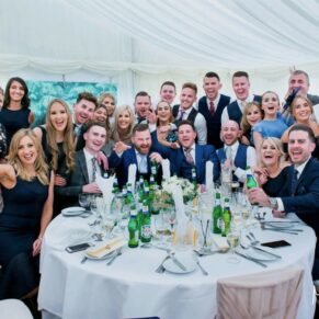 Buckinghamshire Marquee Wedding Photography - group pose of friends inside the marquee