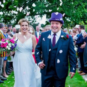 Buckinghamshire Marquee Wedding Photography - confetti aisle and big smiles from the bride and groom