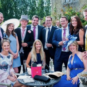 Relaxed friends group pose taken during the drinks reception on the garden terrace