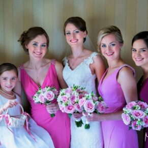 The bride with her bridesmaids captured in a formal pose before the ceremony in the cottage at the venue