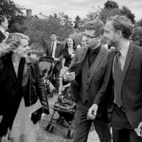Guests enjoy a chat as they approach the church for the marriage ceremony