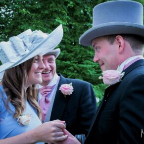 Three guests captured in a relaxed candid pose during this summer drinks reception